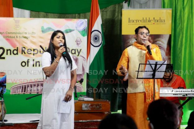 Paritosh Kumar Sinha, right, performs a patriotic song, with by Savita Singh, during the ceremony marking the 72nd Republic Day of India